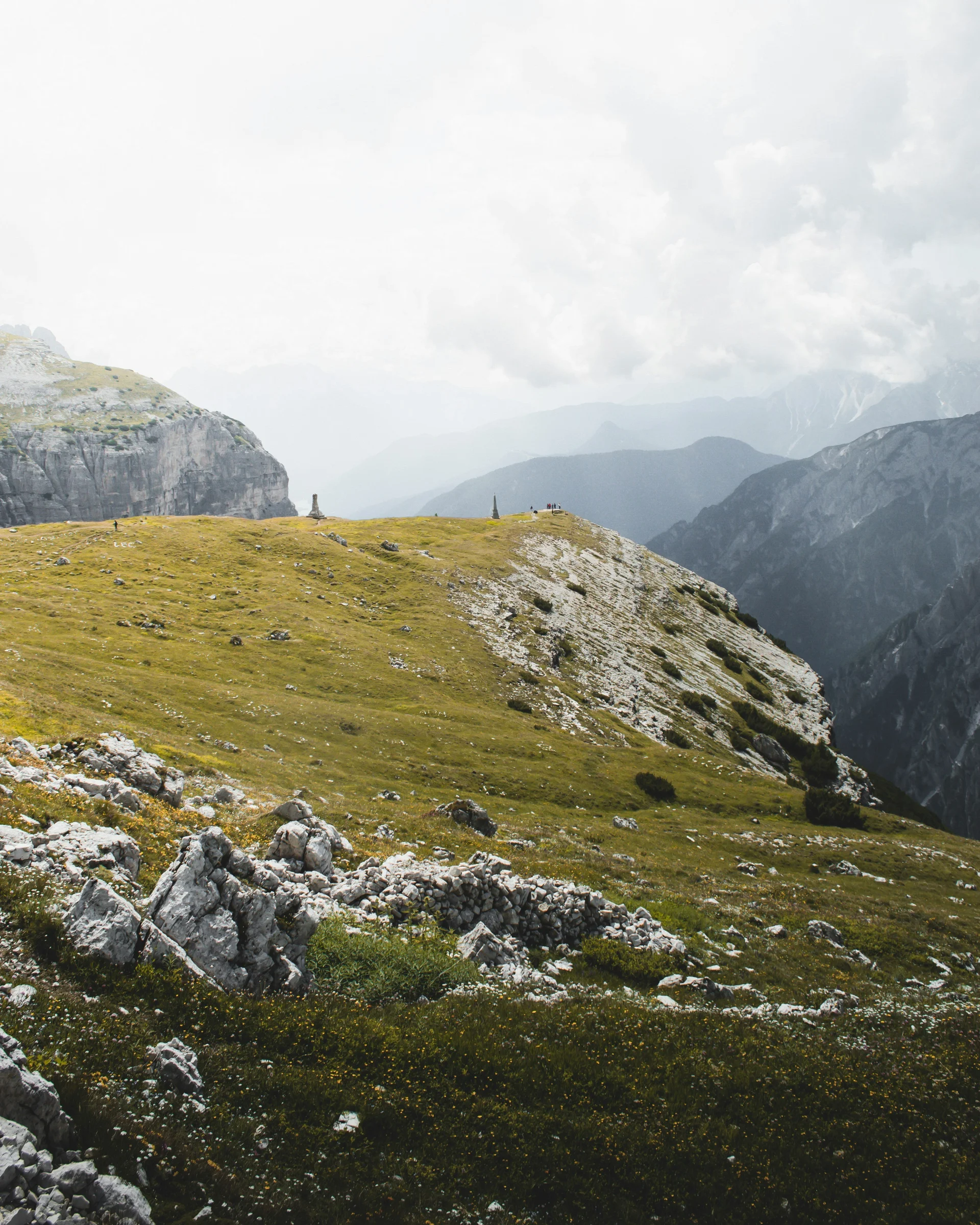 A hideaway for your exclusive holiday in Val Pusteria/Pustertal Green mountain meadow with rocks and cloudy sky in the Alps
