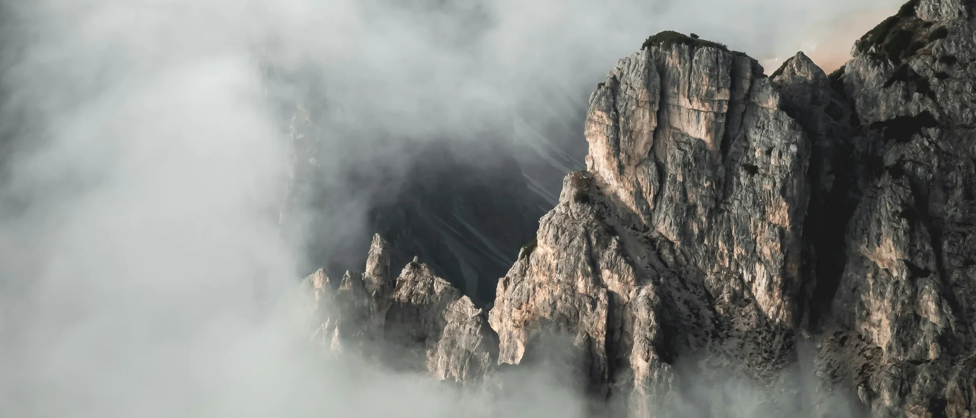 Enriching winter holidays – at our ski hotel in the Dolomites Rocky mountain peaks surrounded by thick fog