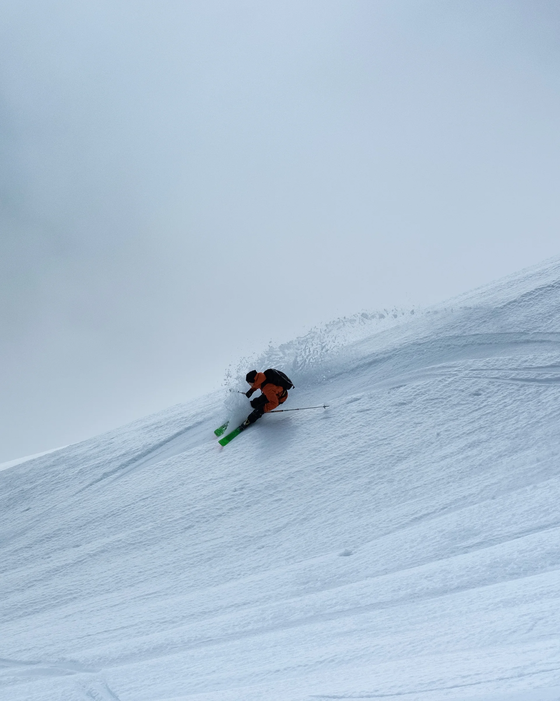 Enriching winter holidays – at our ski hotel in the Dolomites Skier descending steep snowy mountain in fog