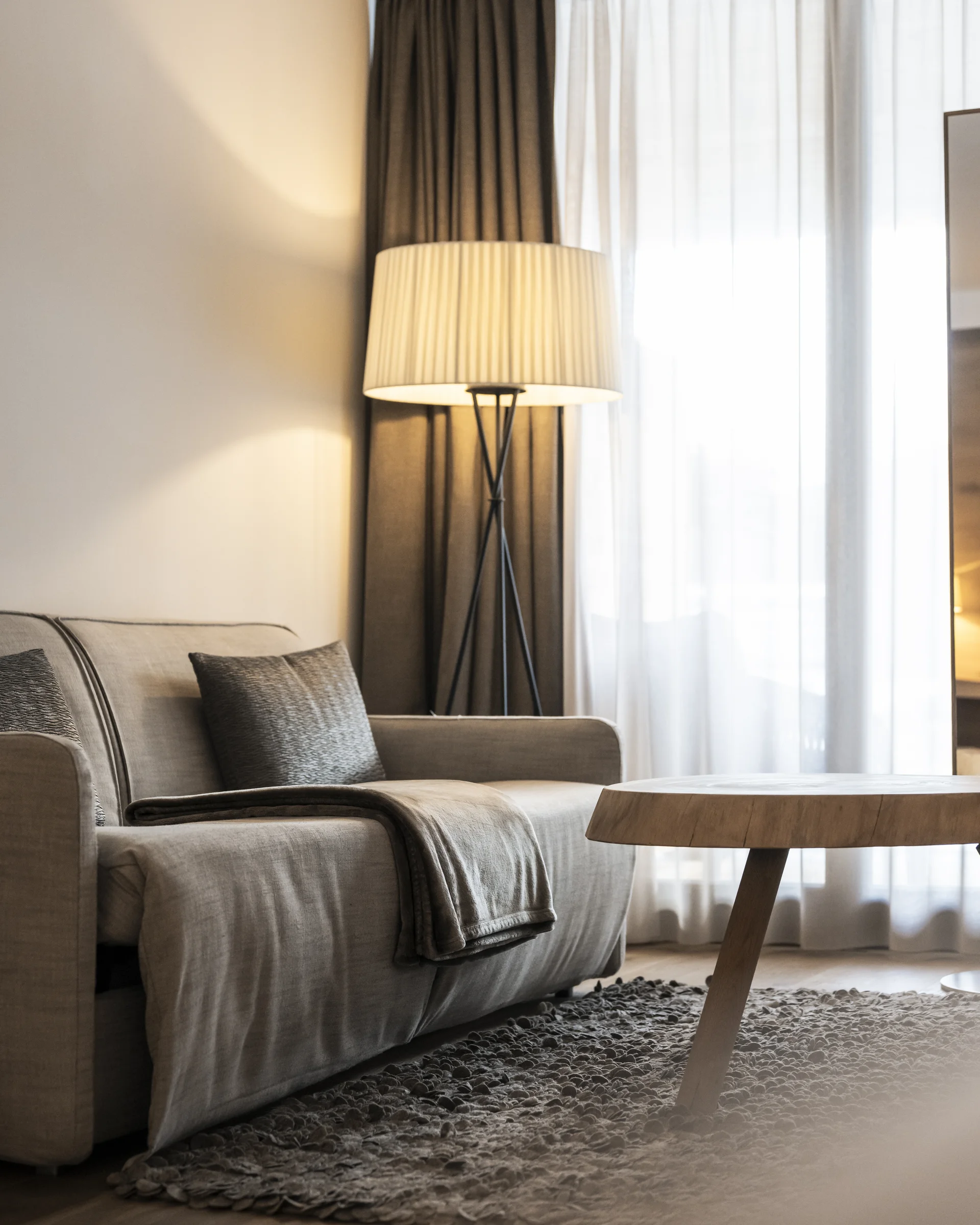 Hotel Monika: a new dimension of luxury Modern living room with sofa, floor lamp, and round wooden coffee table