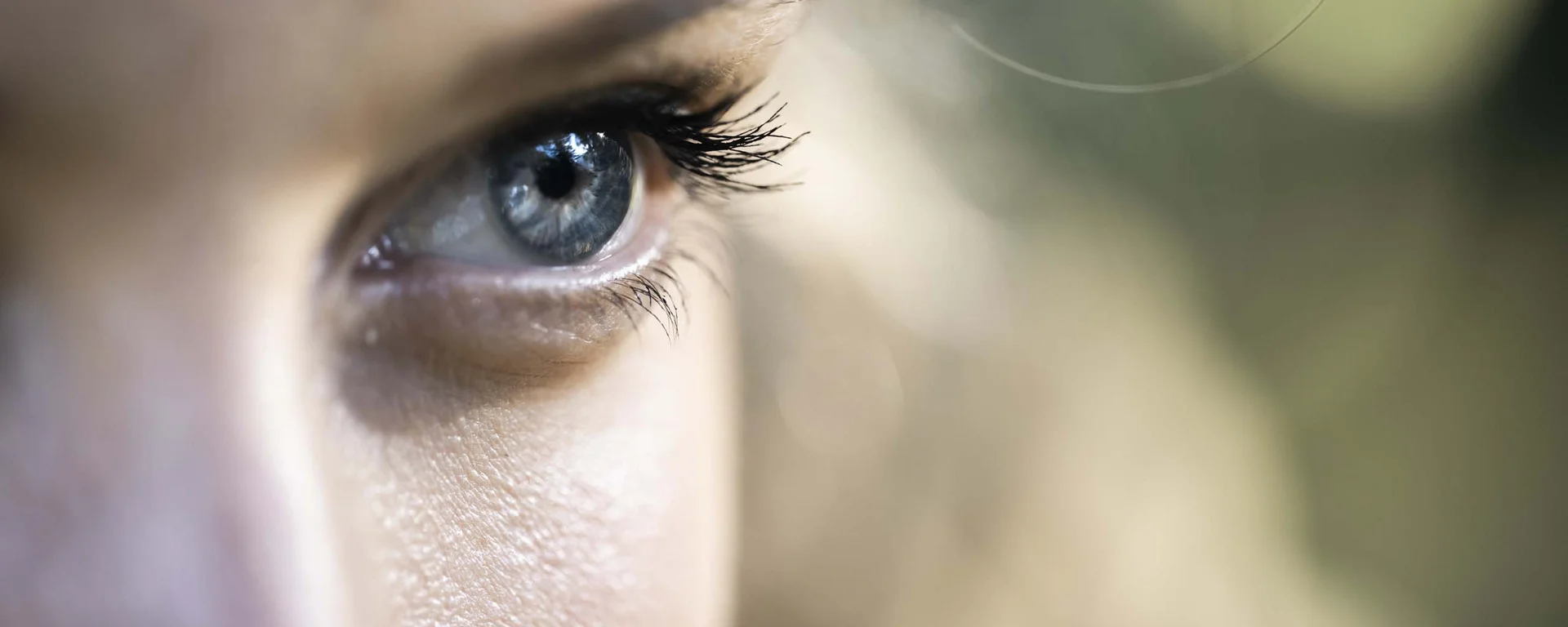Luxury from nature: your sustainable hotel in South Tyrol. Close-up of a blue eye with long eyelashes