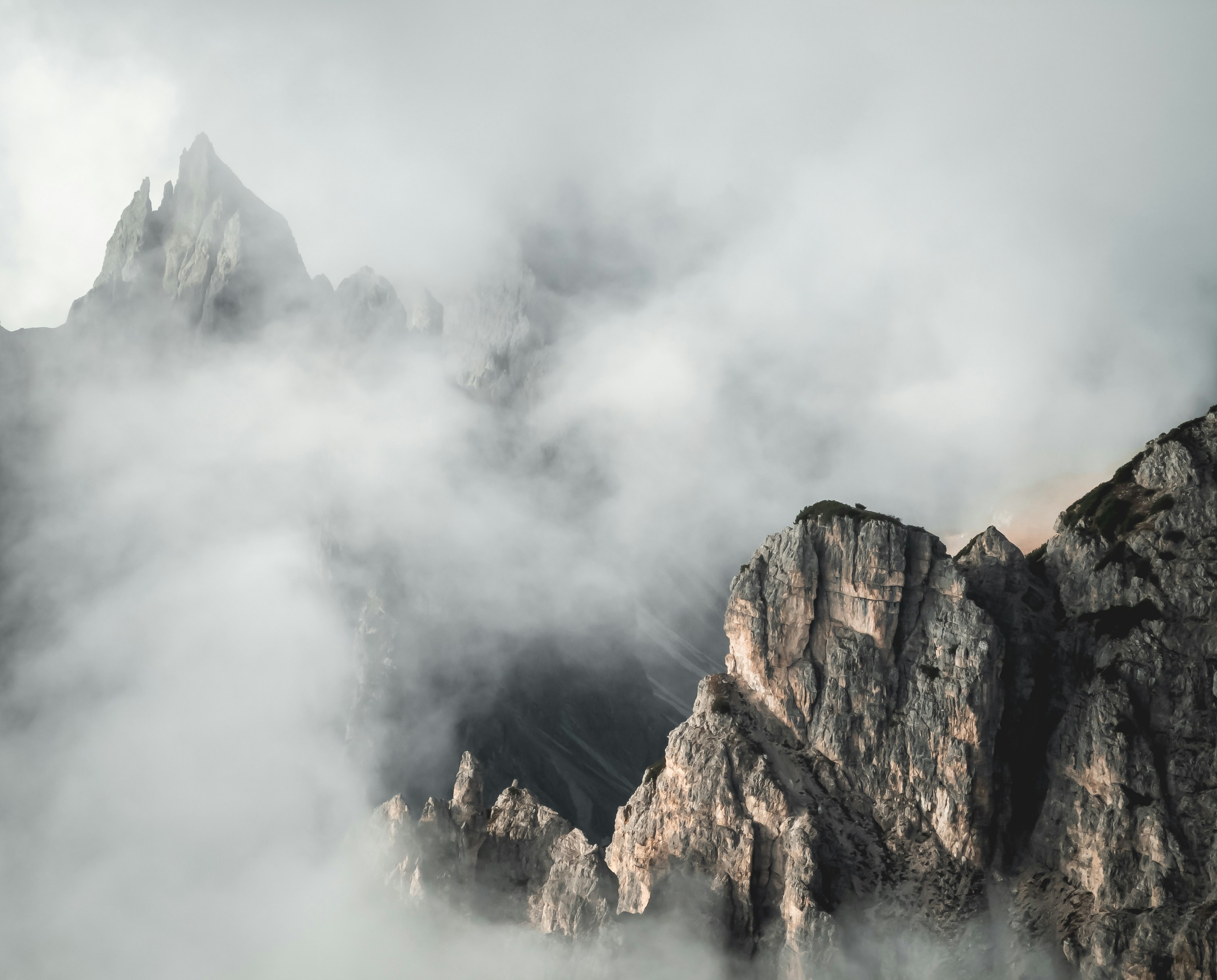 Holiday in and with nature: your adventure hotel in South Tyrol. Rocky mountain peaks surrounded by thick fog