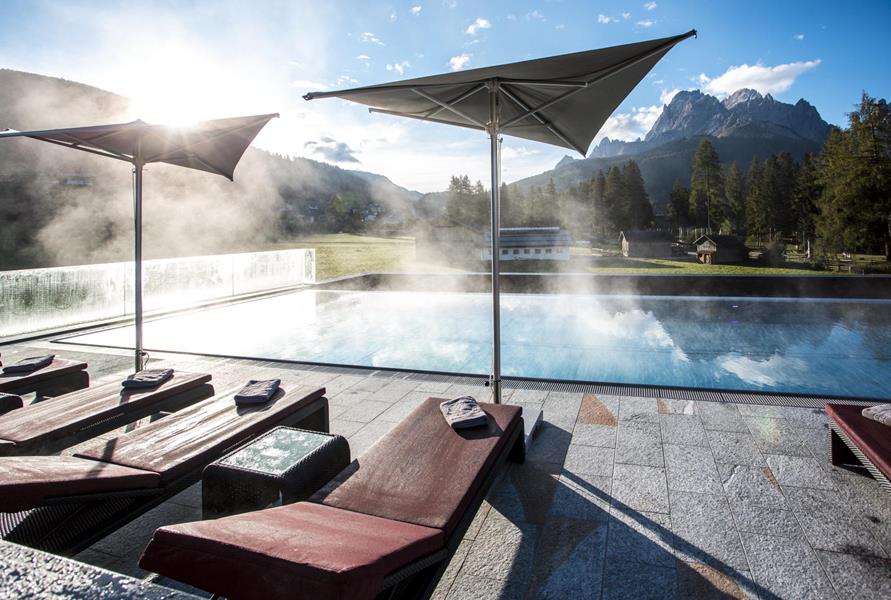 Outdoor pool with loungers and a view